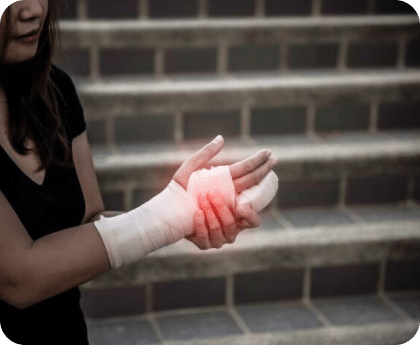 Person holding their bandaged wrist with highlighted red area indicating pain