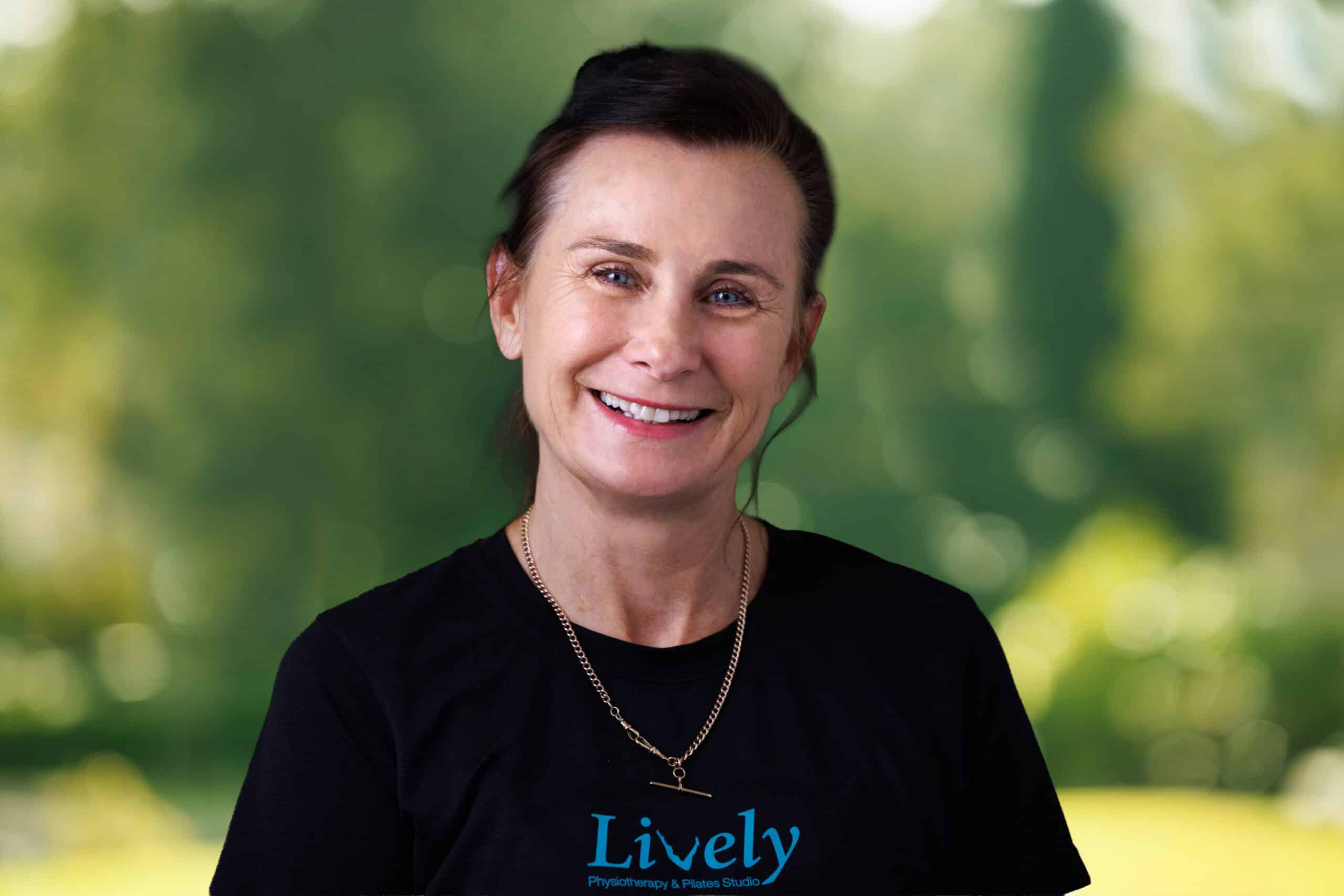Kerry Furrer, team member at Lively Physio, smiling outdoors in a black Lively Physio top